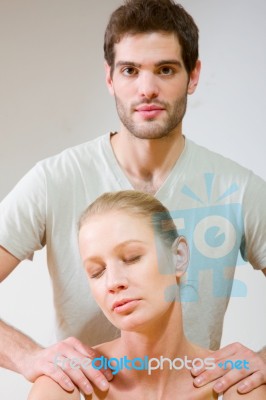 Man Massaging Womans Shoulders Stock Photo