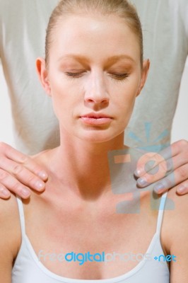 Man Massaging Womans Shoulders Stock Photo
