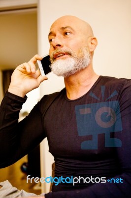 Man Middle-aged Talking On His Smartphone Stock Photo
