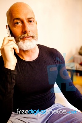 Man Middle-aged Talking On His Smartphone Stock Photo