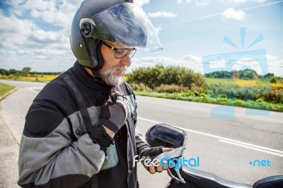 Man Motorcyclist In Protective Helmet Looking At Smartphone Disp… Stock Photo