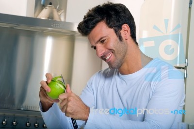 Man Peeling Apple Stock Photo
