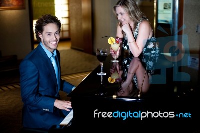 Man Playing Piano With His Lover Stock Photo