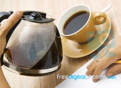 Man Pouring Coffee Into Cup Stock Photo