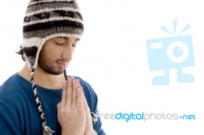 Man Praying with woolen Cap Stock Photo