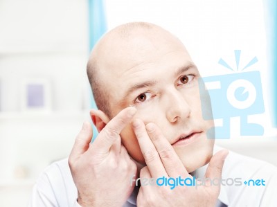 Man Putting Contact Lens In Eye Stock Photo