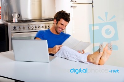 Man Reading Newspaper Laptop Kitchen Stock Photo