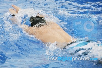Man Swims In Swimming Pool Stock Photo