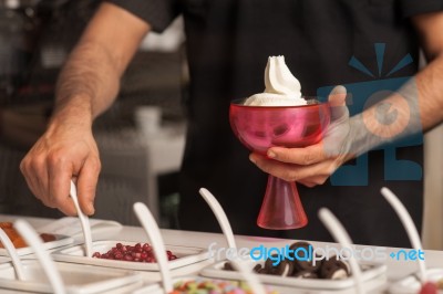 Man Topping Ice-cream With Gems And Jellies Stock Photo