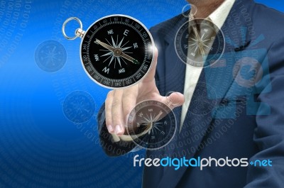 Man Touching Compass Stock Photo