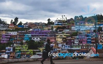 Man Walking In Front Of A Tightly Packed Colorful Village In Ind… Stock Photo