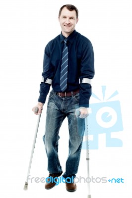 Man Walking With Crutches Isolated On White Stock Photo