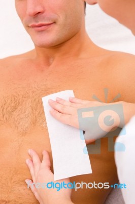 Man Waxing His Chest Hair Stock Photo