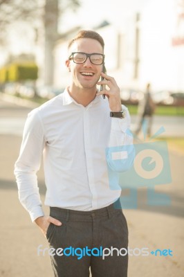 Man With Glasses Speak On Mobile Phone In Hands Stock Photo