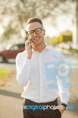 Man With Glasses Speak On Mobile Phone In Hands Stock Photo