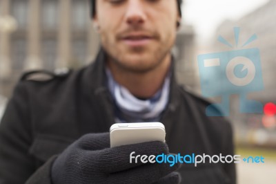 Man With Mobile Phone In Hands Stock Photo
