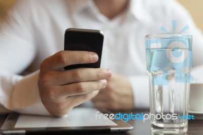 Man With Smartphone And Tablet Computer In Restaurant Stock Photo