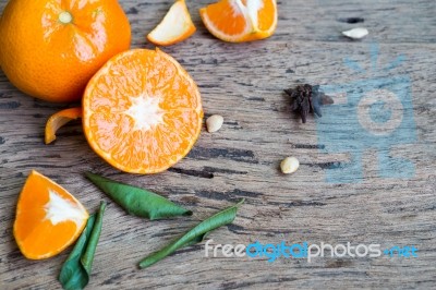 Mandarin Orange And Leaf On Wooden Background Stock Photo