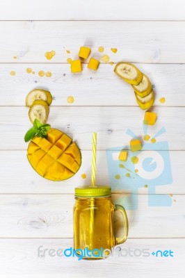 Mango And Banana Smoothie In Mason Jar With Straw Stock Photo