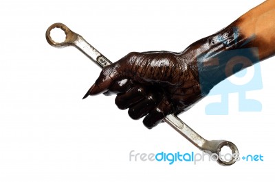 Man's Hand And Wrench In Engine Oil Stock Photo