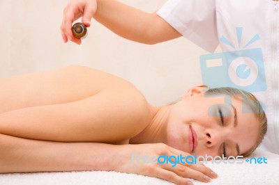 Masseuse Pouring Massage Oil Woman's Back Stock Photo