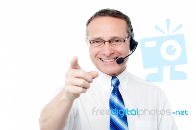 Mature Business Execuitve With Headset Stock Photo