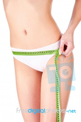 Measure Tape Around Slim Woman's Hip Stock Photo
