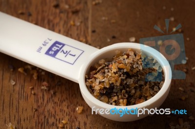 Measuring Spoon On Wooden Background Stock Photo