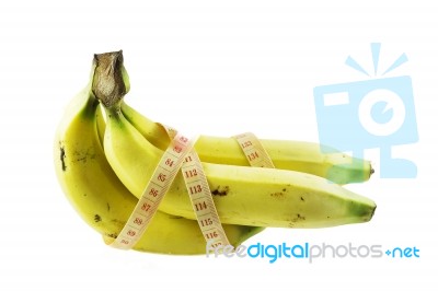 Measuring Tape Wrapped Around Bananas. Concept Of Diet Stock Photo