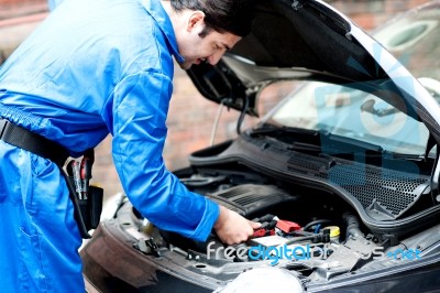 Mechanic Repairing Car's Engine Stock Photo