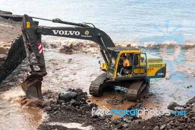 Mechanical Digger Clearing The River Outlet To The Sea From Stor… Stock Photo