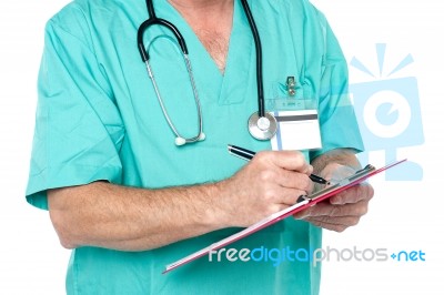 Medical Expert Jotting Down Case Sheet Notes Stock Photo