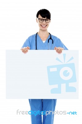 Medical Practitioner Holding Blank Ad Board Stock Photo