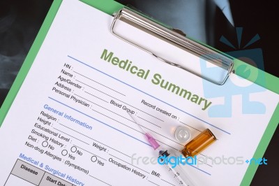 Medical Record And Syringe With Medicine Bottles Stock Photo