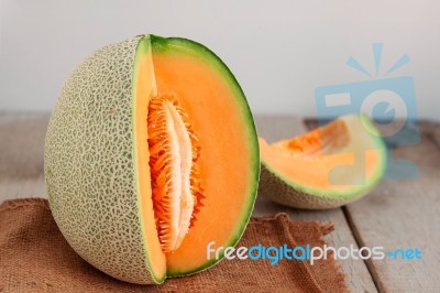 Melon Cut On Wooden Stock Photo