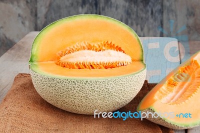 Melon Cut On Wooden Stock Photo