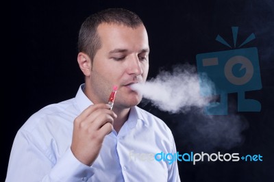 Men Smoke An Electronic Cigarette Stock Photo