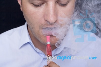 Men Smoke An Electronic Cigarette Stock Photo