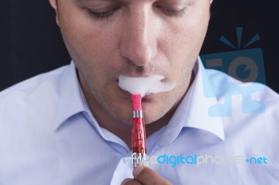Men Smoke An Electronic Cigarette Stock Photo