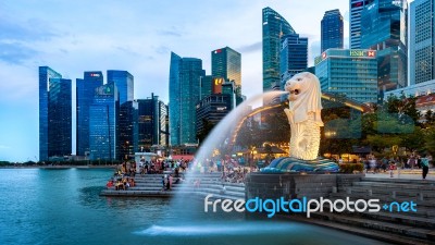 Merlion Statue And Cityscape In Singapore Stock Photo