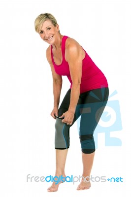 Middle Age Woman With 
Patellar Knee Brace Stock Photo