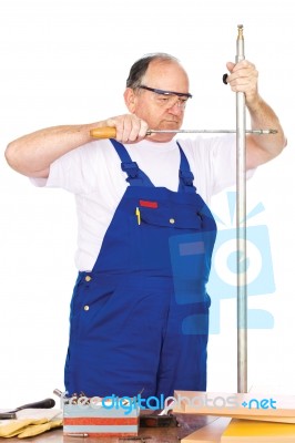 Middle Age Worker Cutting Metal Pipe Stock Photo