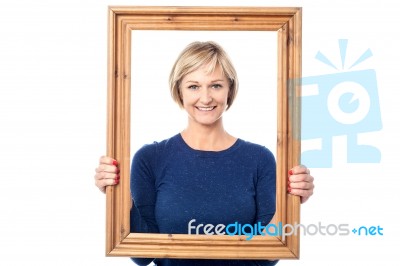 Middle Aged Lady Holding Photo Frame Stock Photo