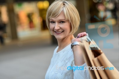 Middle Aged Woman Holding Shopping Bags Stock Photo