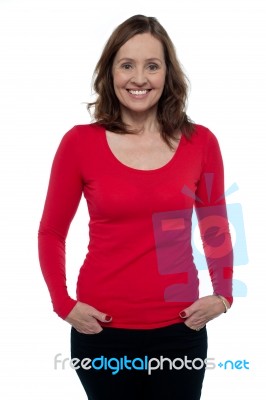 Middle Aged Woman In Bright Red Top Stock Photo