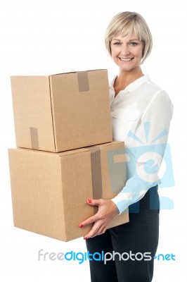 Middle Aged Woman Moving Packed Boxes Stock Photo