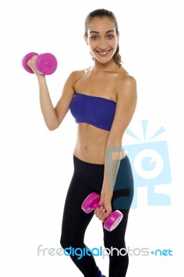 Middle Aged Woman Posing With Pink Dumbbells Stock Photo