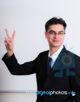 Middle Eastern Business Man Showing Victory Sign Stock Photo