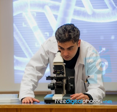 Scientist And Microscope Stock Photo