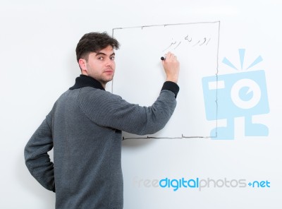 Teacher Writing On Whiteboard Stock Photo